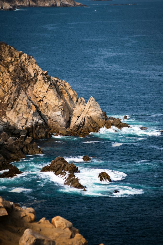 Rocky ocean coast with waves breaking on the rocks.